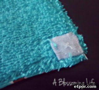 Sewing Velcro squares onto the corners of unpaper towels for connection