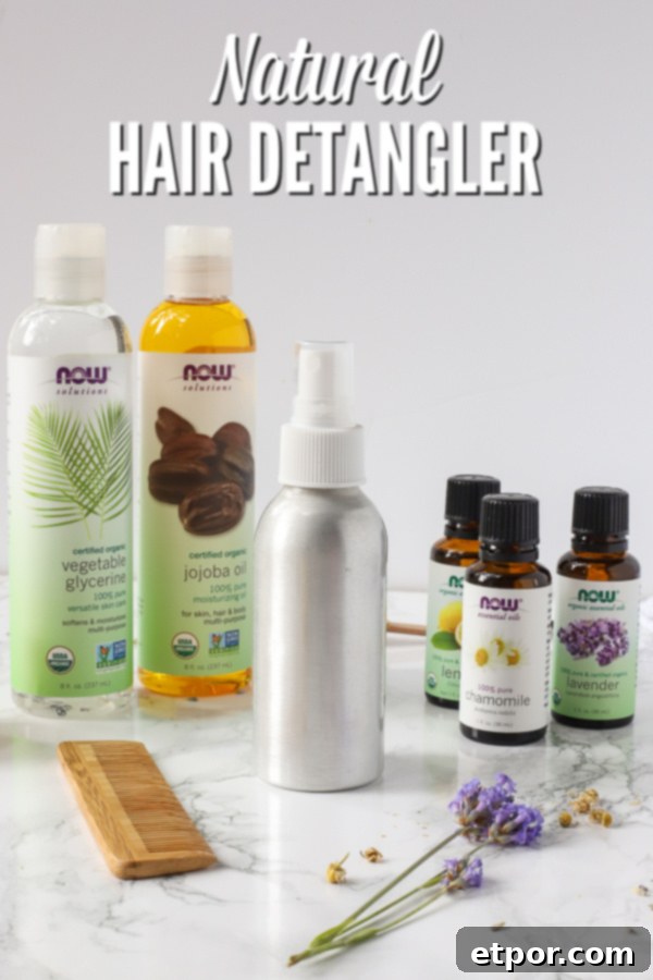 Homemade natural hair detangler spray in a metal bottle, surrounded by its natural ingredients like essential oils, jojoba oil, vegetable glycerin, and apple cider vinegar.