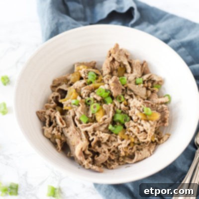 Effortless Chicago Style Italian Beef 4 Italian beef recipe in a bowl on top a blue napkin with antique forks