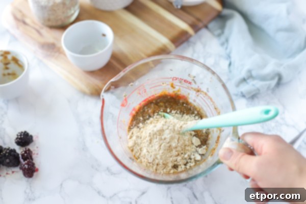 Power-Packed Blackberry Protein Cookies 7 Vegan protein powder in in a glass measuring cup