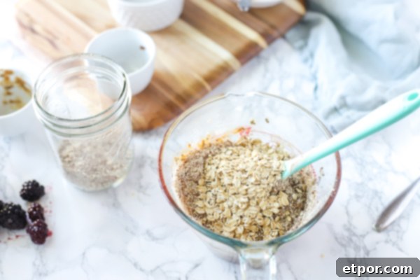 Power-Packed Blackberry Protein Cookies 8 Pyrex glass measuring cup filled with ingredients - adding oatmeal