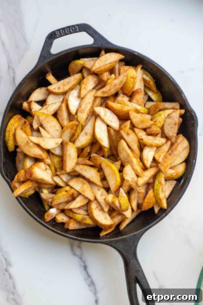 Pear filling in a cast iron skillet.