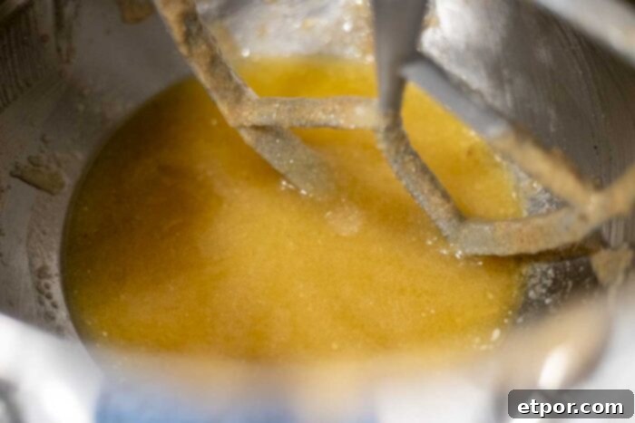 Artisan Chocolate Chunk Muffins with Whole Grain Sourdough 4 eggs, sugar, butter, and sourdough starter in a stand mixer bowl.