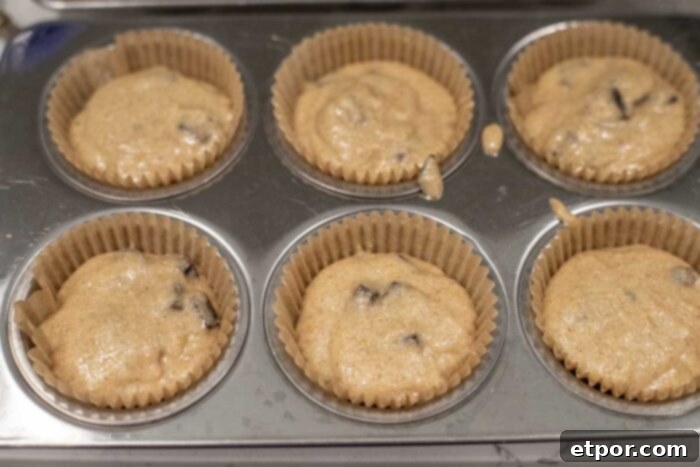 Artisan Chocolate Chunk Muffins with Whole Grain Sourdough 7 Muffin batter in lined muffin tins.