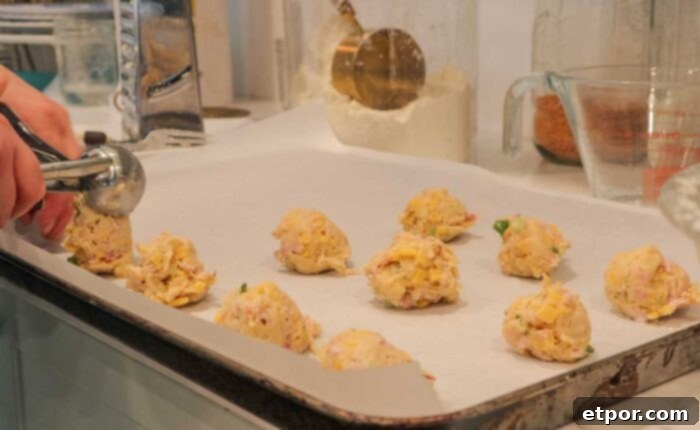 Scooping biscuit dough onto a baking sheet.